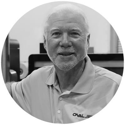 Headshot of Kris Friedrich in front of the OvalJet